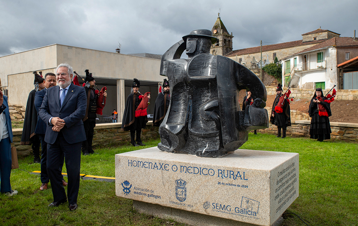 Miguel Santalices, presidente del Parlamento de Galicia, junto a la escultura que Laza dedica al médico rural.